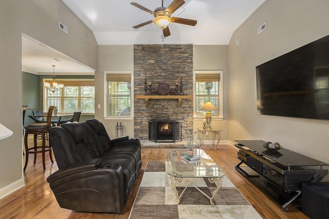 212 Westwind Dr, Newnan, GA 30263 - living area with ceiling fan, wood finished floors, a chandelier, a fireplace, and vaulted ceiling