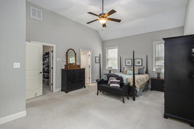 212 Westwind Dr, Newnan, GA 30263 - bedroom with a spacious closet, light colored carpet, vaulted ceiling, a ceiling fan, and a closet