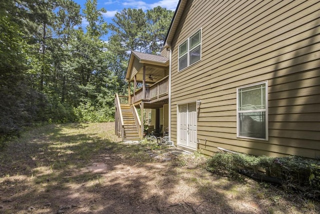 212 Westwind Dr, Newnan, GA 30263 - view of side of home featuring ceiling fan, stairway, and a deck
