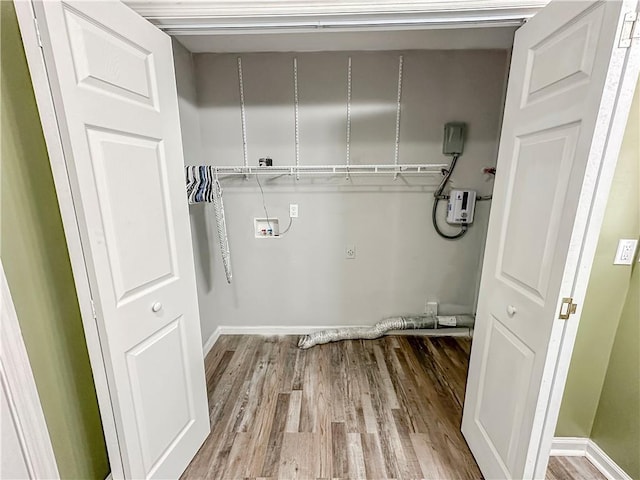 laundry area with hookup for a washing machine and light hardwood / wood-style flooring