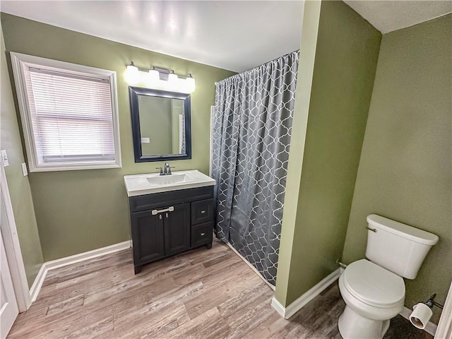 bathroom with vanity, hardwood / wood-style floors, a shower with curtain, and toilet