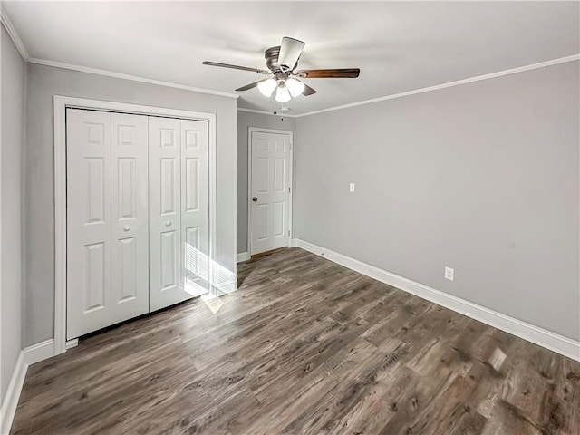 unfurnished bedroom with dark hardwood / wood-style flooring, ornamental molding, a closet, and ceiling fan