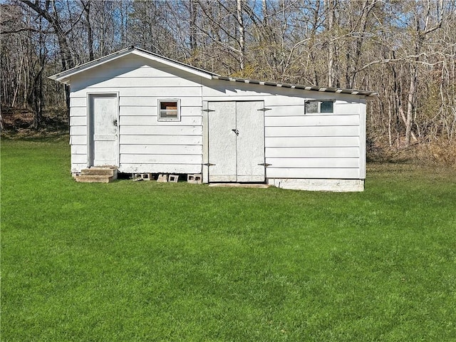 view of outdoor structure with a lawn