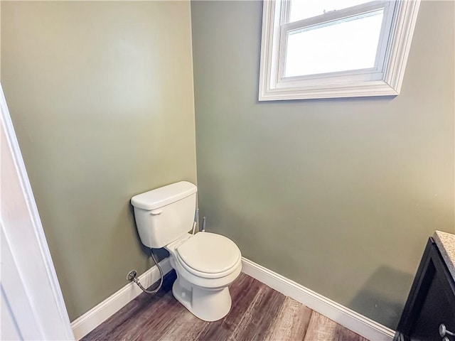 bathroom with vanity, hardwood / wood-style floors, and toilet