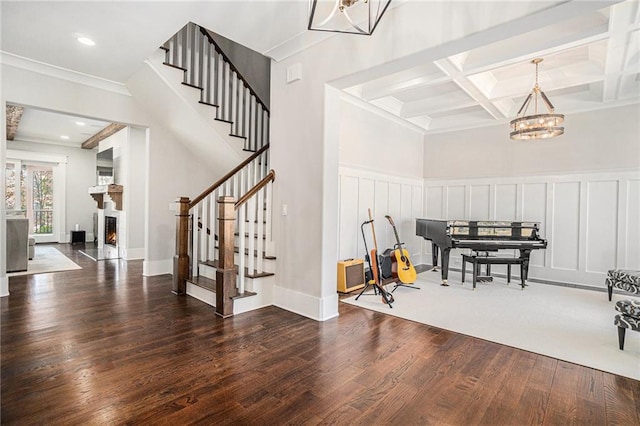 entryway featuring a chandelier, coffered ceiling, stairway, beamed ceiling, and dark wood finished floors