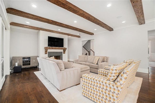 living room with stairway, wood finished floors, beamed ceiling, a lit fireplace, and recessed lighting