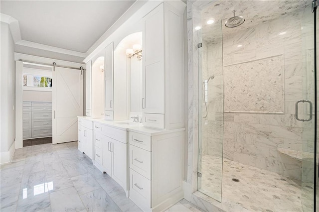 full bathroom featuring marble finish floor, crown molding, a marble finish shower, vanity, and baseboards