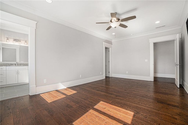 unfurnished bedroom featuring crown molding, visible vents, a sink, and wood finished floors