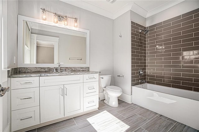 bathroom with washtub / shower combination, vanity, and toilet