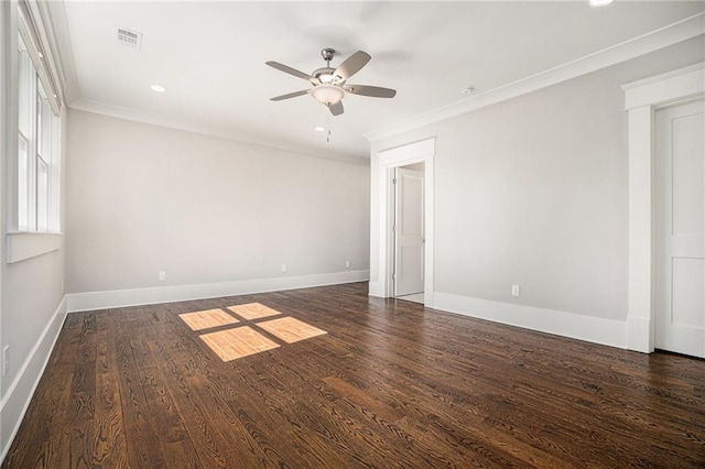 empty room with baseboards, visible vents, a ceiling fan, ornamental molding, and wood finished floors