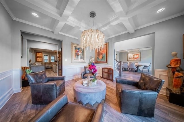 149 Avalon Way, Sharpsburg, GA 30277 - living area with a chandelier, coffered ceiling, beam ceiling, wood finished floors, and a wainscoted wall