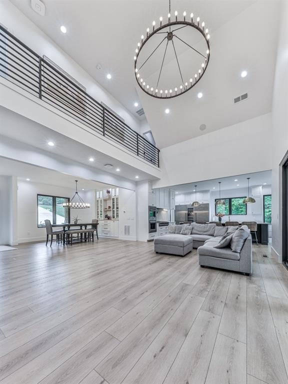 106 Belmont Dr, Canton, GA 30115 - living room featuring a chandelier, a towering ceiling, light wood-style flooring, and recessed lighting