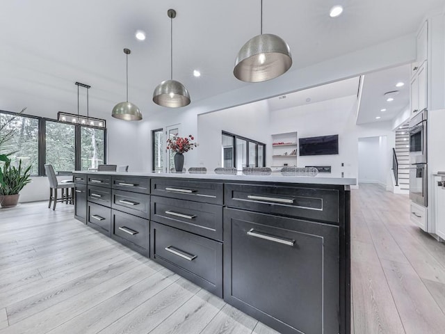 106 Belmont Dr, Canton, GA 30115 - kitchen featuring white cabinetry, light wood finished floors, light countertops, dark cabinetry, and recessed lighting