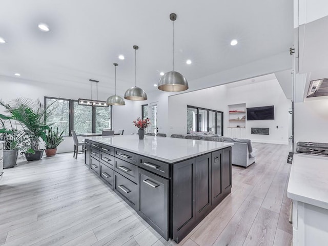 106 Belmont Dr, Canton, GA 30115 - kitchen with light countertops, light wood finished floors, recessed lighting, pendant lighting, and a center island
