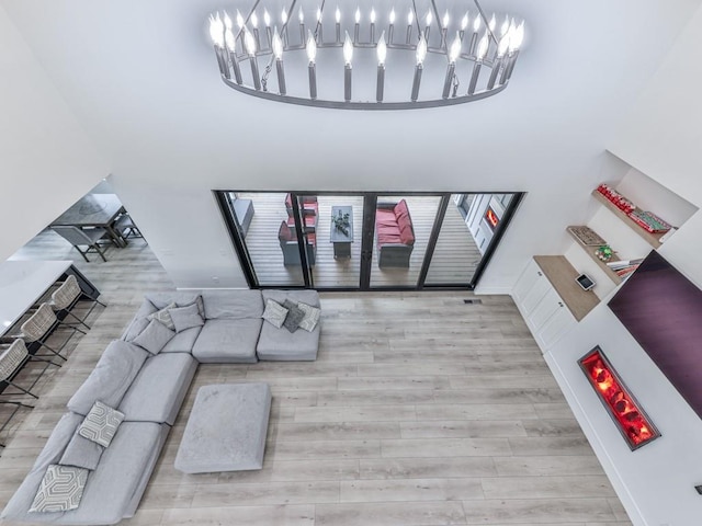 106 Belmont Dr, Canton, GA 30115 - living room with a chandelier, wood finished floors, and a towering ceiling