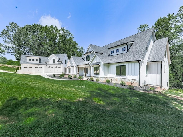 106 Belmont Dr, Canton, GA 30115 - modern farmhouse style home with board and batten siding, roof with shingles, a front lawn, and stone siding
