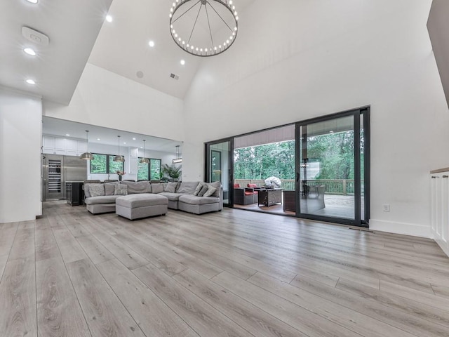 106 Belmont Dr, Canton, GA 30115 - living room with light wood-style floors, plenty of natural light, a high ceiling, a chandelier, and recessed lighting