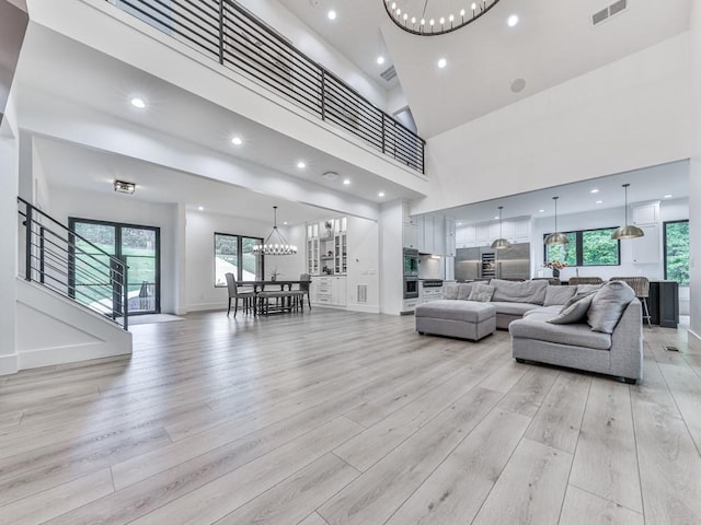 106 Belmont Dr, Canton, GA 30115 - living room featuring a chandelier, light wood-style flooring, plenty of natural light, a high ceiling, and recessed lighting