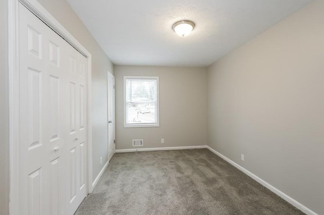 unfurnished bedroom featuring a closet and carpet