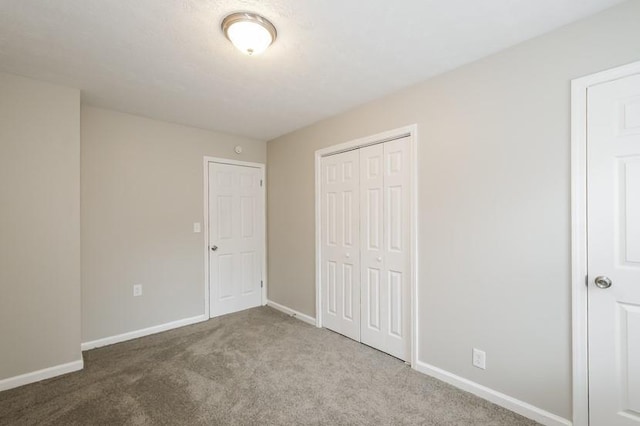 unfurnished bedroom featuring carpet flooring and a closet