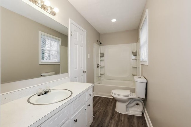 full bathroom featuring hardwood / wood-style flooring, shower / bathtub combination, vanity, and toilet