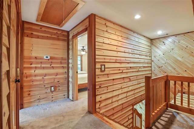 929 Hickory Nut Mountain Rd, Tallulah Falls, GA 30573 - hall featuring wooden walls, attic access, carpet flooring, recessed lighting, and an upstairs landing