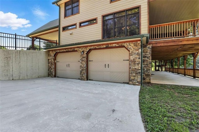 929 Hickory Nut Mountain Rd, Tallulah Falls, GA 30573 - view of side of property featuring a garage, stone siding, and driveway