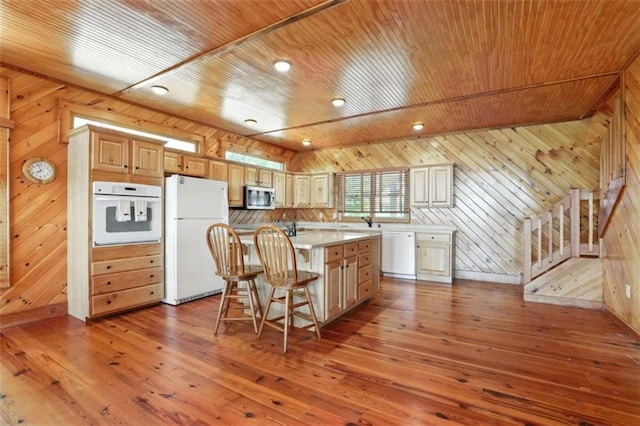 929 Hickory Nut Mountain Rd, Tallulah Falls, GA 30573 - kitchen with white appliances, wooden walls, wood ceiling, wood-type flooring, and a kitchen breakfast bar