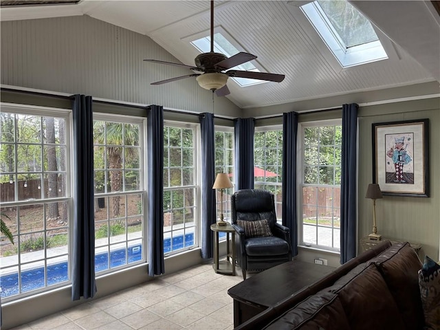 sunroom with vaulted ceiling, a skylight, and tile patterned flooring