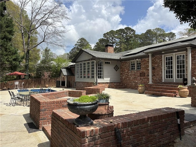 view of patio featuring fence, entry steps, and french doors