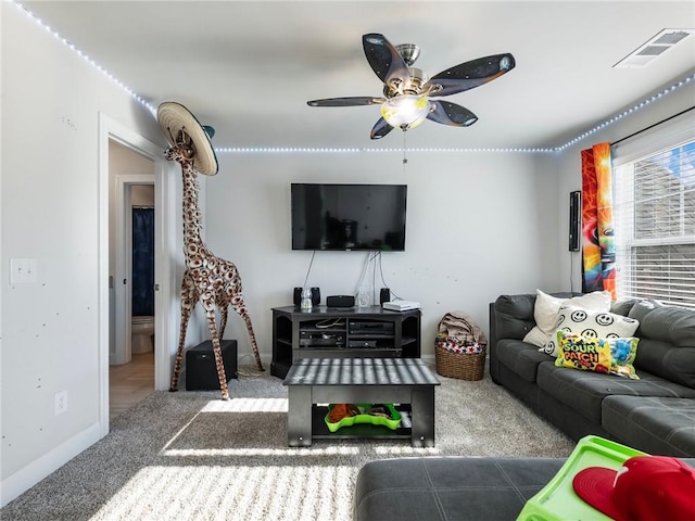 living room featuring carpet and ceiling fan