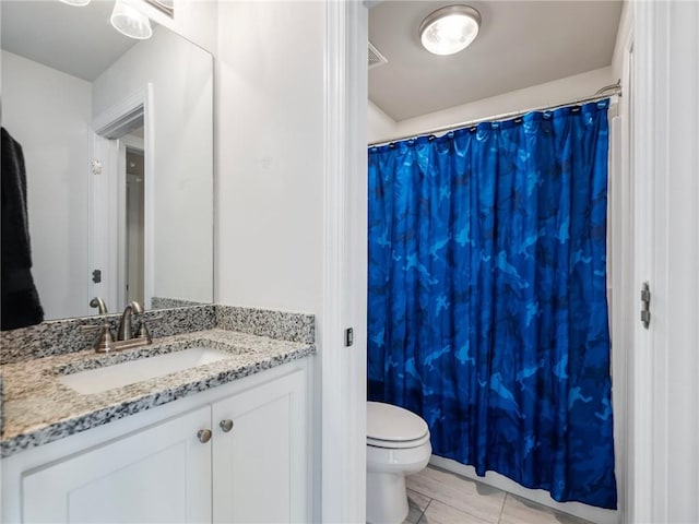 bathroom with vanity, toilet, and tile patterned floors