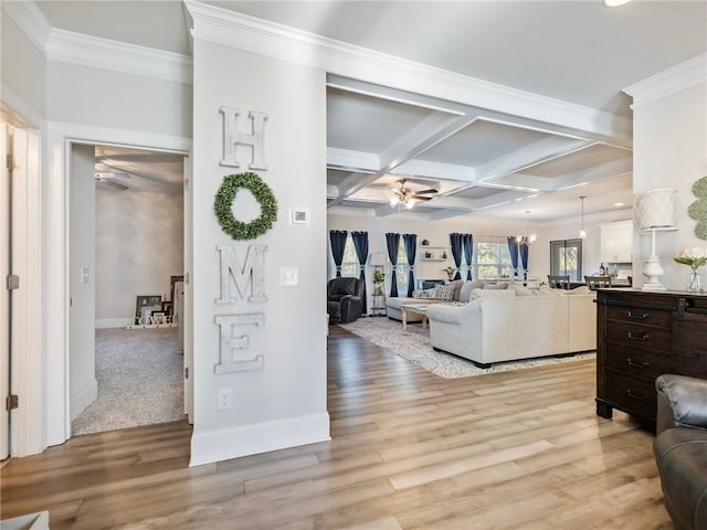 living room featuring coffered ceiling, beam ceiling, light hardwood / wood-style flooring, crown molding, and ceiling fan with notable chandelier