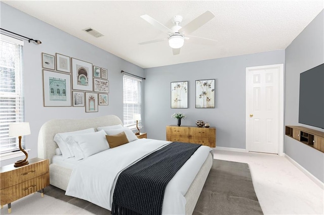 bedroom with ceiling fan and carpet