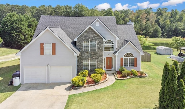 view of property featuring a front yard and a garage