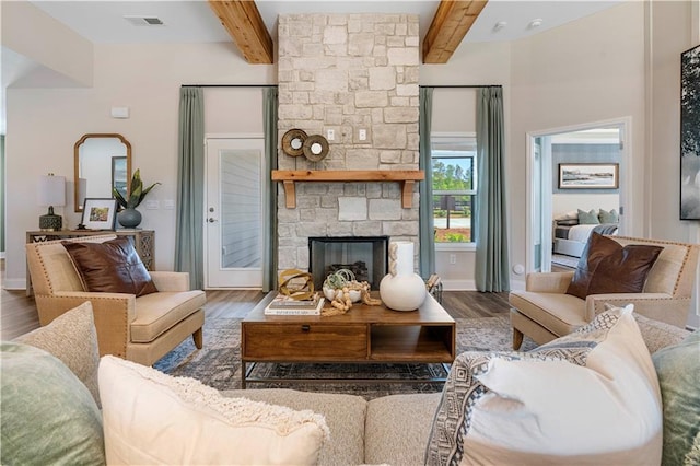 living room with beam ceiling, a fireplace, and dark hardwood / wood-style flooring