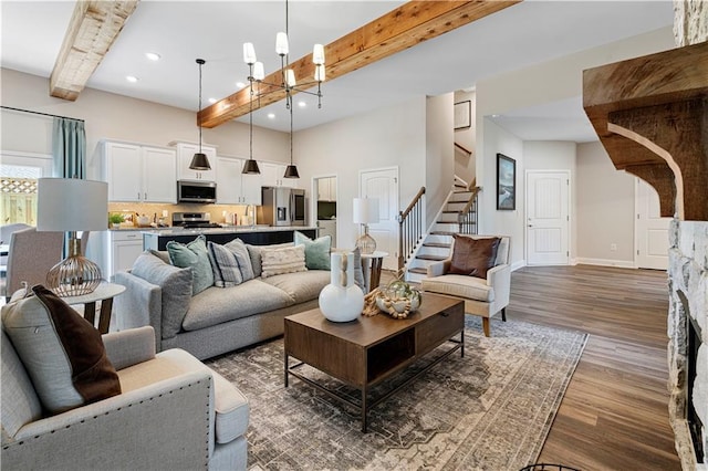 living room featuring beamed ceiling, a chandelier, and dark wood-type flooring