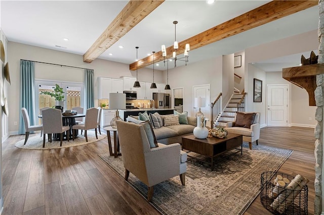 living room with beamed ceiling, dark hardwood / wood-style flooring, and a chandelier