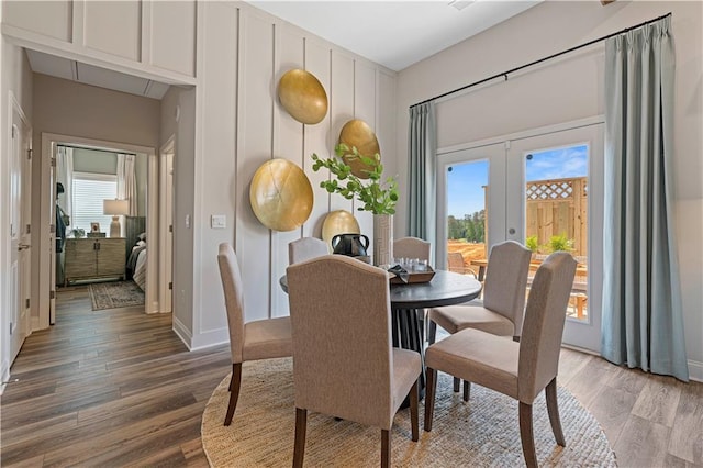 dining room featuring hardwood / wood-style flooring and french doors