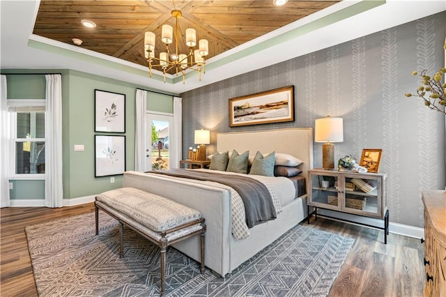 bedroom with wood ceiling, dark hardwood / wood-style flooring, a raised ceiling, and a notable chandelier