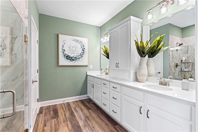 bathroom with vanity, hardwood / wood-style floors, and walk in shower