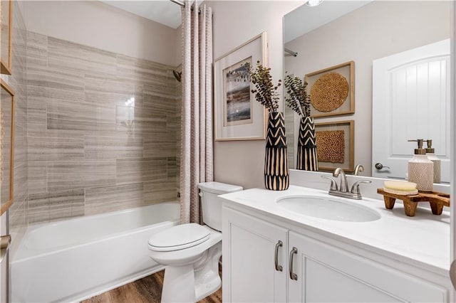 full bathroom with vanity, wood-type flooring, shower / bath combination with curtain, and toilet