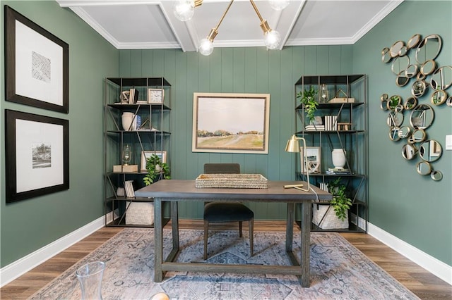 home office with an inviting chandelier, ornamental molding, and wood-type flooring