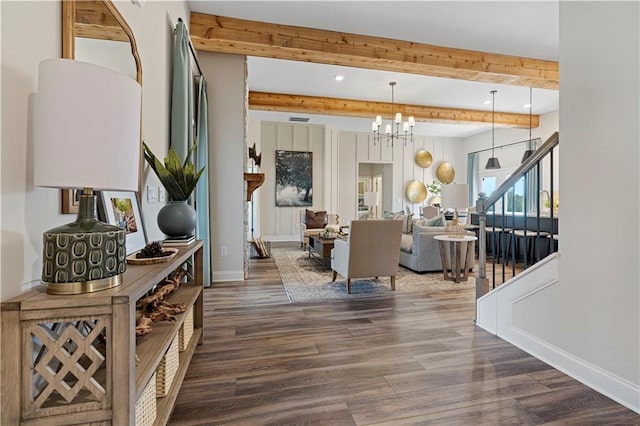 dining space featuring beam ceiling, dark wood-type flooring, and a chandelier