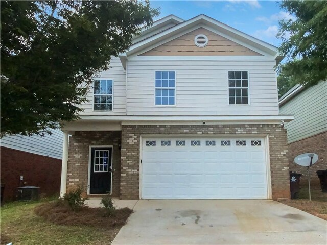 view of front of house featuring central AC unit and a garage