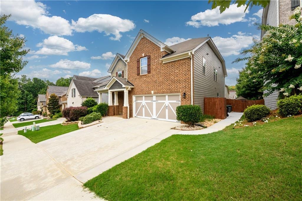 view of front of home featuring a garage and a front lawn