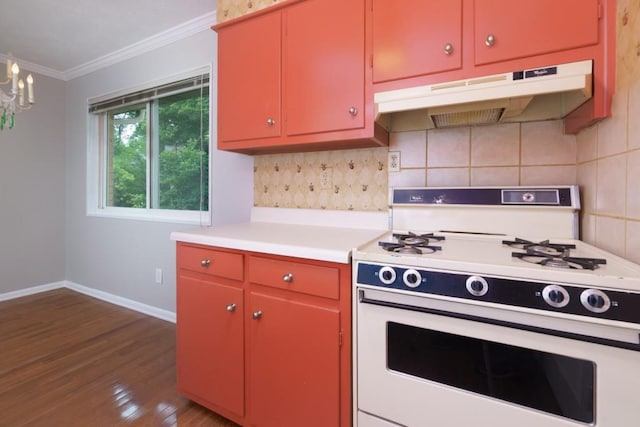 kitchen with white range with gas cooktop, dark wood finished floors, under cabinet range hood, crown molding, and red cabinetry