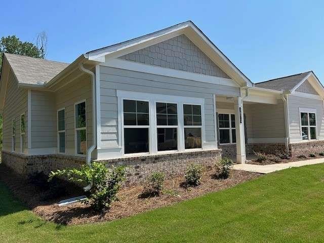 view of side of property with a yard