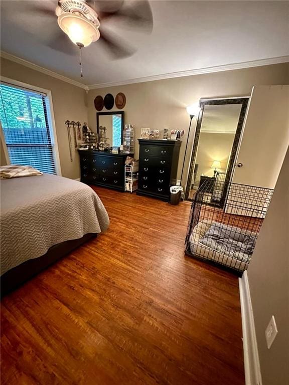 bedroom featuring hardwood / wood-style flooring, ceiling fan, and ornamental molding