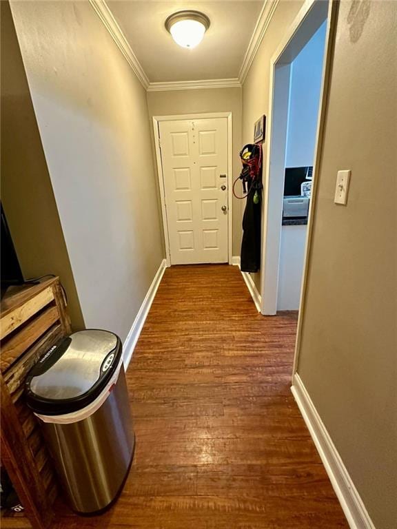 corridor featuring ornamental molding and hardwood / wood-style flooring